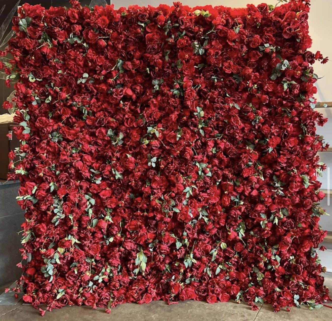 The Rosalia flower wall: red roses with greenery